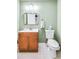 Basement bathroom with wood vanity and light green walls at 5060 Rosedown Pl, Roswell, GA 30076