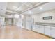 Open concept basement kitchenette, white cabinets and granite countertops at 5060 Rosedown Pl, Roswell, GA 30076