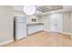 Basement kitchenette with white cabinets and granite countertops at 5060 Rosedown Pl, Roswell, GA 30076