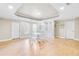 Bright basement recreation room, featuring built-in shelving and hardwood floors at 5060 Rosedown Pl, Roswell, GA 30076