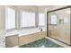 Elegant bathroom with soaking tub, separate shower, and green tile floor at 5060 Rosedown Pl, Roswell, GA 30076