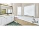 Bathroom with a soaking tub, granite countertop, and green tile floor at 5060 Rosedown Pl, Roswell, GA 30076