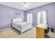 Lavender bedroom with a white bed, desk and window shutters at 5060 Rosedown Pl, Roswell, GA 30076