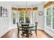 Bright breakfast nook with an oval table and four chairs, overlooking the backyard at 5060 Rosedown Pl, Roswell, GA 30076