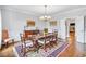 Formal dining room with hardwood floors, chandelier, and large windows at 5060 Rosedown Pl, Roswell, GA 30076