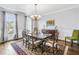 Formal dining room featuring hardwood floors, a chandelier, and an area rug at 5060 Rosedown Pl, Roswell, GA 30076