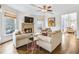 Gathering room with stone fireplace, hardwood floors and plenty of natural light at 5060 Rosedown Pl, Roswell, GA 30076