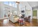 Two-story living room with hardwood floors, fireplace, and built-in shelves at 5060 Rosedown Pl, Roswell, GA 30076