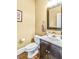 Powder room with dark vanity, white countertop, and yellow walls at 5060 Rosedown Pl, Roswell, GA 30076