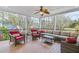 Covered porch with wicker furniture and ceiling fan, offering shade and comfort at 5060 Rosedown Pl, Roswell, GA 30076