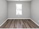 Simple bedroom with window and wood-look floors at 533 Halley Way, Stockbridge, GA 30281