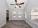 Sunroom with grey walls, wood-look flooring, and many windows at 533 Halley Way, Stockbridge, GA 30281