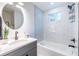 Bright bathroom featuring a tub, tiled walls, a modern vanity, and updated fixtures at 116 Turman Se Ave, Atlanta, GA 30315