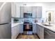 Modern kitchen with stainless steel appliances and gray cabinetry provides a sleek and stylish cooking space at 116 Turman Se Ave, Atlanta, GA 30315