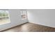 Spacious bedroom with wood-look floors and two windows at 3094 Jonesboro St, Ellenwood, GA 30294