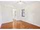 Well-lit bedroom featuring hardwood floors, white walls, and an accessible ensuite at 320 3Rd Ne St # 1, Atlanta, GA 30308