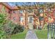 Inviting brick townhouse with a black door awning, a walkway to the entrance, and well-kept landscaping on a sunny day at 320 3Rd Ne St # 1, Atlanta, GA 30308