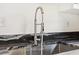 Close up of a sink with a spring faucet and black countertops at 320 3Rd Ne St # 1, Atlanta, GA 30308