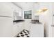 Galley kitchen boasts checkerboard floors, white cabinets, and sleek black countertops at 320 3Rd Ne St # 1, Atlanta, GA 30308
