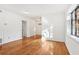 Bright living room features hardwood floors, white walls, and large window for ample natural light at 320 3Rd Ne St # 1, Atlanta, GA 30308