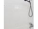 A white tiled shower with a black shower head at 320 3Rd Ne St # 1, Atlanta, GA 30308