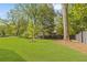 Private backyard with mature trees and a modern fence at 3566 Cantrell Ne Rd, Atlanta, GA 30319