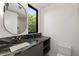 Modern bathroom with dark marble vanity and a frameless mirror at 3566 Cantrell Ne Rd, Atlanta, GA 30319