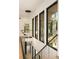 Bright hallway with glass railing, light wood floors, and modern chandelier at 3566 Cantrell Ne Rd, Atlanta, GA 30319