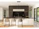 Modern kitchen with a large island, dark cabinetry, and marble countertops at 3566 Cantrell Ne Rd, Atlanta, GA 30319