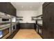 Modern kitchen boasts dark cabinetry, stainless steel appliances, and light hardwood floors at 3566 Cantrell Ne Rd, Atlanta, GA 30319