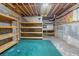 Unfinished basement with wooden shelving and a green carpeted area at 5615 Forkwood Nw Dr, Acworth, GA 30101