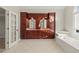 Bathroom with double vanity, large mirror and a corner bathtub at 5615 Forkwood Nw Dr, Acworth, GA 30101