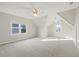Large bedroom with vaulted ceiling, carpet, and multiple windows at 5615 Forkwood Nw Dr, Acworth, GA 30101