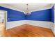 Formal dining room with hardwood floors and blue walls at 5615 Forkwood Nw Dr, Acworth, GA 30101