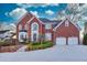 Brick home with two-car garage and landscaped yard at 5615 Forkwood Nw Dr, Acworth, GA 30101
