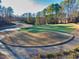 Undulating green with mature trees and landscaping at 5615 Forkwood Nw Dr, Acworth, GA 30101