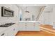 White kitchen with gas range and stainless steel appliances at 5615 Forkwood Nw Dr, Acworth, GA 30101