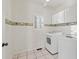 Bright laundry room with washer, dryer, and built-in cabinets at 5615 Forkwood Nw Dr, Acworth, GA 30101