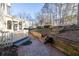 Brick patio with wooden retaining walls and landscaping at 5615 Forkwood Nw Dr, Acworth, GA 30101