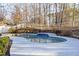 Kidney-shaped swimming pool with concrete decking at 5615 Forkwood Nw Dr, Acworth, GA 30101