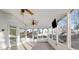 Sunroom featuring tile floors, two ceiling fans, and large windows at 5615 Forkwood Nw Dr, Acworth, GA 30101