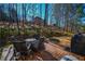 Deck with seating area, grill, and wooded backdrop at 605 Rose Creek Cir, Duluth, GA 30097