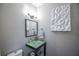 Stylish bathroom with glass sink, dark vanity, and a white toilet at 605 Rose Creek Cir, Duluth, GA 30097