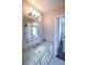 Bathroom with granite countertop, single sink vanity, and mirrored medicine cabinet at 605 Rose Creek Cir, Duluth, GA 30097