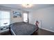 Bright bedroom with large windows, hardwood floors, and modern art at 605 Rose Creek Cir, Duluth, GA 30097
