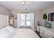 Bright bedroom with large window, plush bedding, and ample closet space at 605 Rose Creek Cir, Duluth, GA 30097