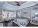 Spacious main bedroom with king-size bed, two armchairs, and large windows at 605 Rose Creek Cir, Duluth, GA 30097