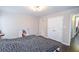King-size bed in a well-lit bedroom with double doors to closet at 605 Rose Creek Cir, Duluth, GA 30097