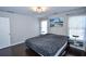 Bedroom with hardwood floors, large windows, and a double door closet at 605 Rose Creek Cir, Duluth, GA 30097