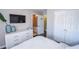 Bedroom with white dresser, large TV, and ensuite bathroom access at 605 Rose Creek Cir, Duluth, GA 30097
